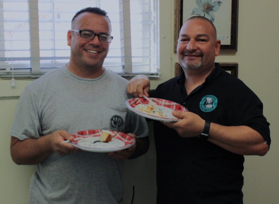 Custodian Juan Amezcua and Plant Manager Sal Rivas enjoy cake in celebration of Amezcuas nomination for California Classified School Employee of the Year.