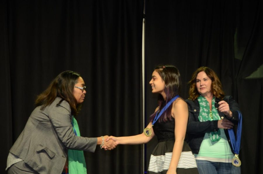 Senior Kaitlyn Arst accepts her award as the co-winner  of the Senior Individual Exhibit category at National History Day on March 17. 