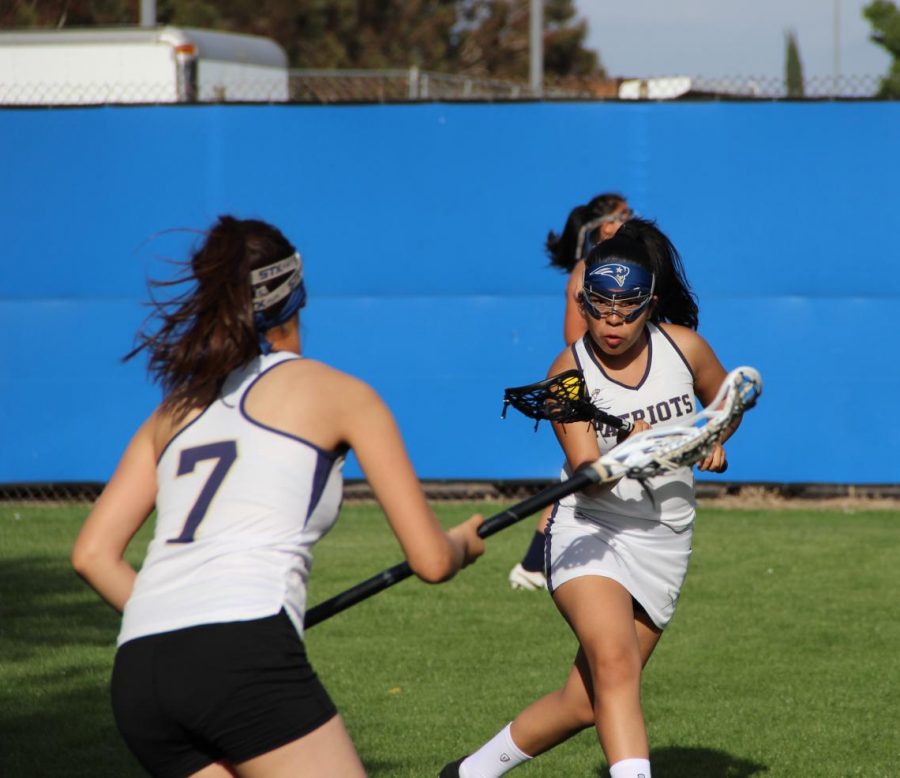 Sophomore Angie Rumbo prepares to swing her shot against an approaching defender.