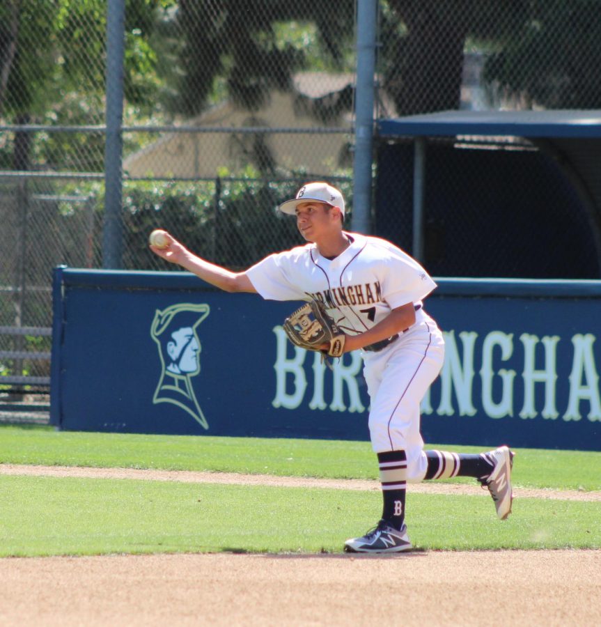 Sophomore Joshua Fleisher throws the baseball to a teammate during a JV prematch.