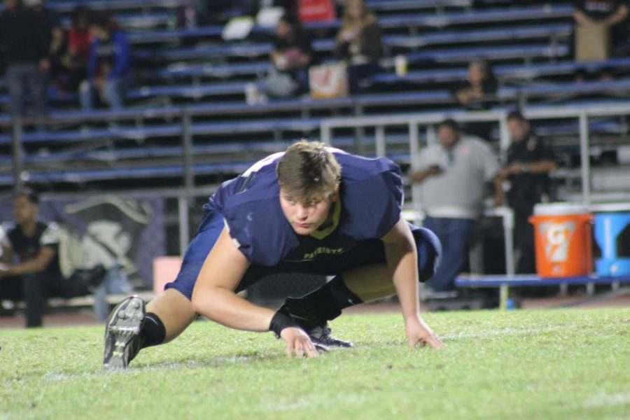 Varsity football player Kyle Matson warming up before last years homecoming game.
