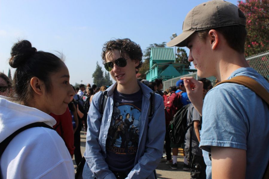 Juniors Mariana Herrera, Ethan Voorheis and Matthew Spar talk outside in the parking lot as they wait to go to nutrition. 