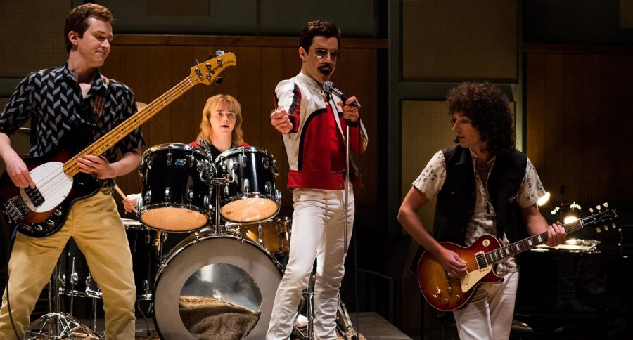 Freddie Mercury, played by Rami Malek, jams out with his band.