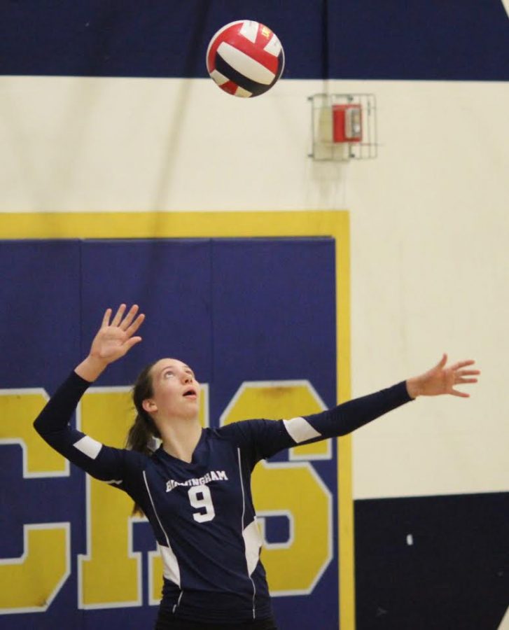 Captain Hailee Kessler serves against Cleveland High School varsity volleyball girls on Oct. 3