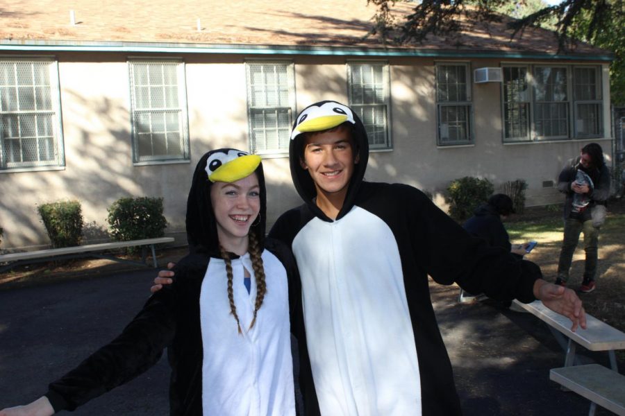 Sophomores Rochelle Polushkin and August Defore wear penguin onesies for Cozy Day on Oct. 29.