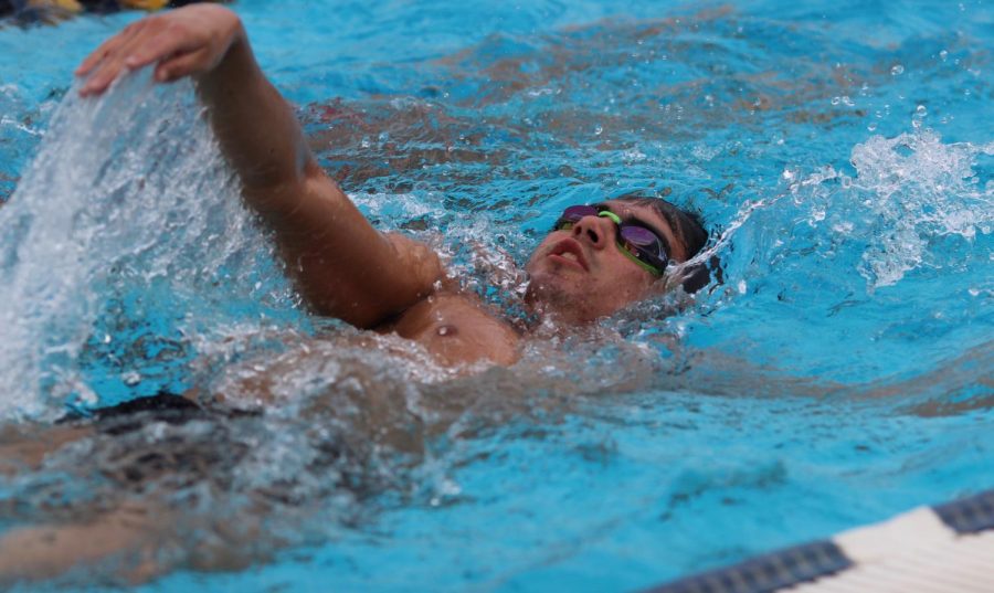 Senior Ben Sanchez performs his backstroke during BCCHS swim practice on Feb. 27.
