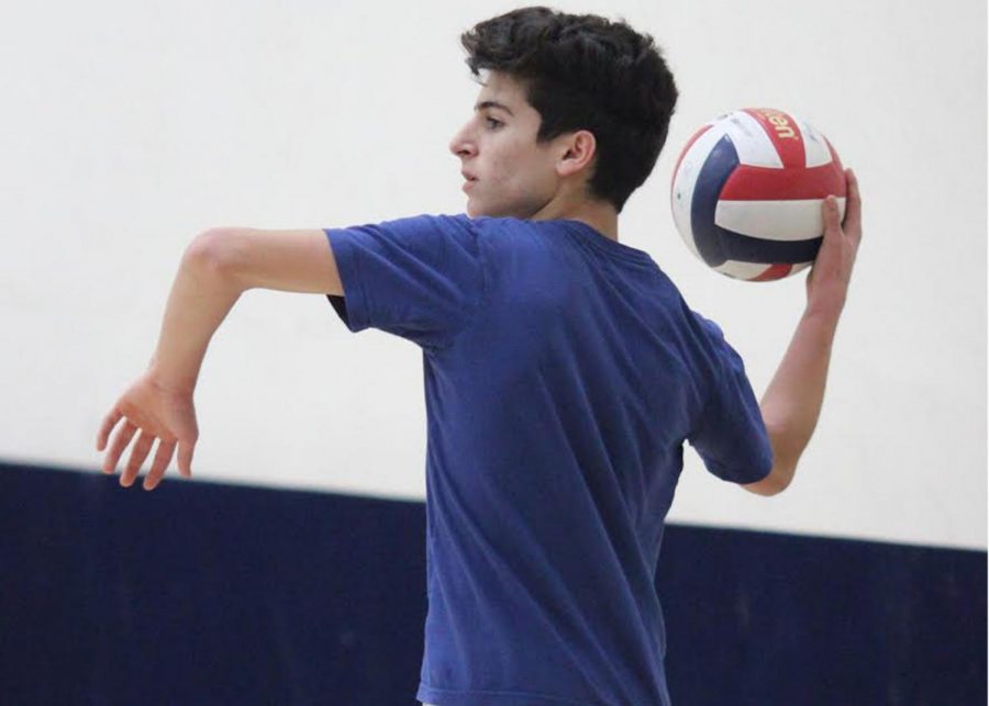 Junior+Rami+Chaar+gets+in+position+to+throw+a+volleyball+in+a+warm+up+game.