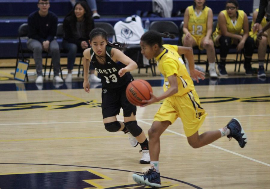 Freshman Janna Holley dribbles the ball during a game against Mira Costa High School on Nov. 28.