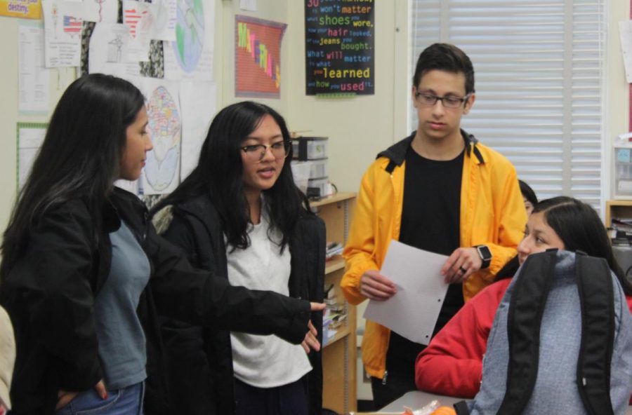 President+Astrid+Cabrera%2C+Treasurer+Karina+Mara+and+Vice+President+Michael+Chidbachian+discuss+National+Honor+Society+volunteering+opportunities+on+Feb.+20.