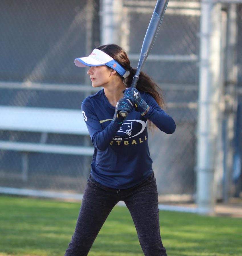 Senior varsity player Genevieve Avalos practices hitting the ball at softball practice on March 14.