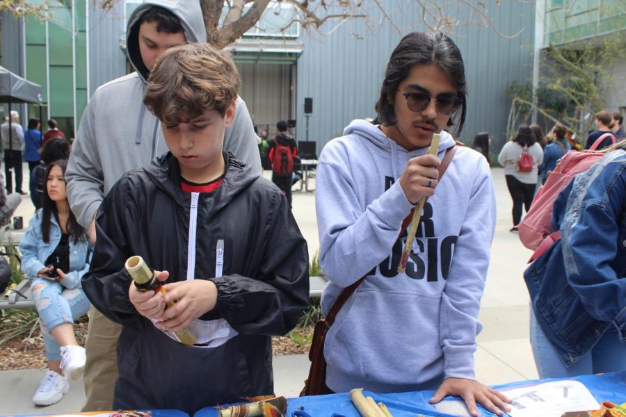 Freshman Branden Gerson and sophomore Jose Ramirez make flutes out of bamboo from the LA river at the Future Currents: Los Angeles River Festival at California State University Northridge. 