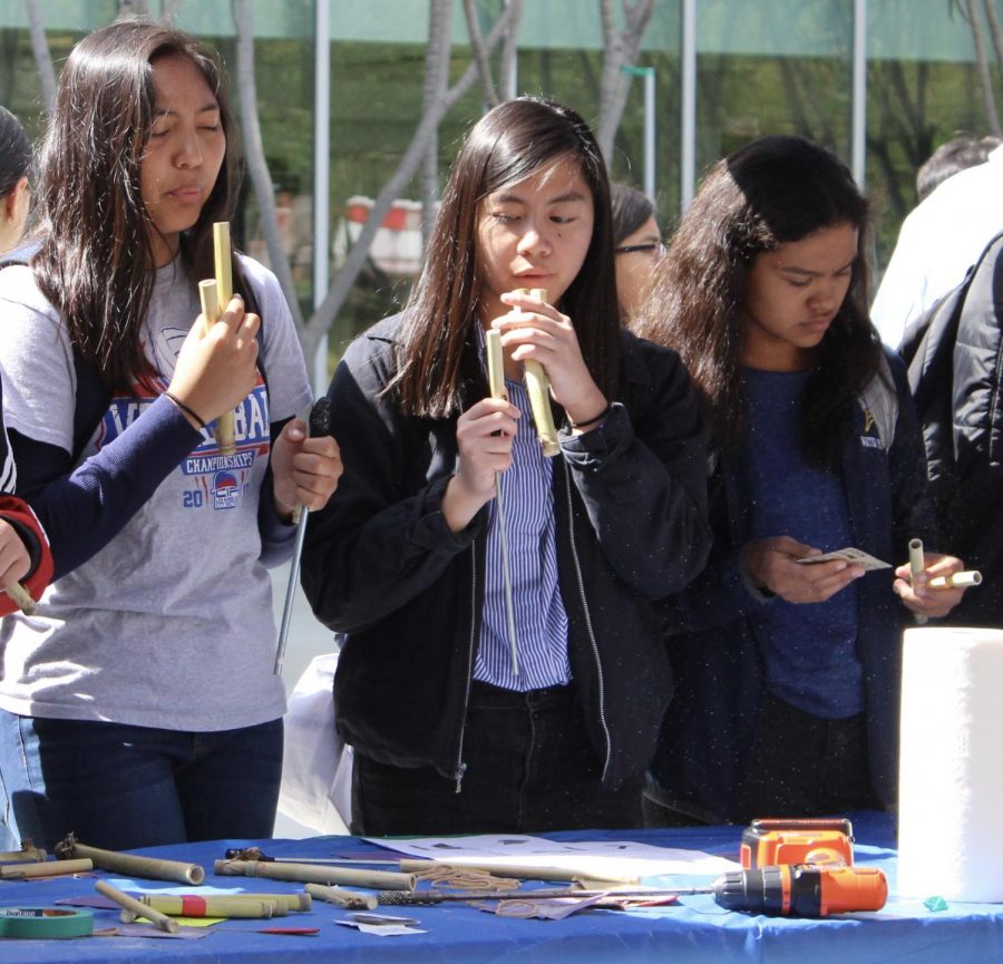 Juniors Keona Paniagua, Kimberly De Dios and sophomore Julissa Jaco make instruments out of bamboo from the LA river on Friday. 