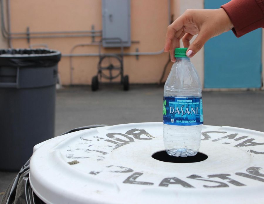 Many+blue+recycling+bins+are+scattered+across+campus+in+order+to+get+more+students+to+recycle+their+empty+bottles+and+to+prevent+littering.