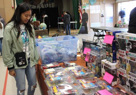 Freshman Chareena Pascua looks at a booth in the vendors room during Pearl Con IV on May 11, 2019.