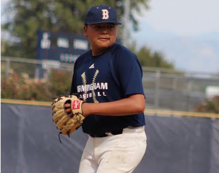 Freshman and varsity player Chris Romero gets ready to pitch the ball during practice on April 8.