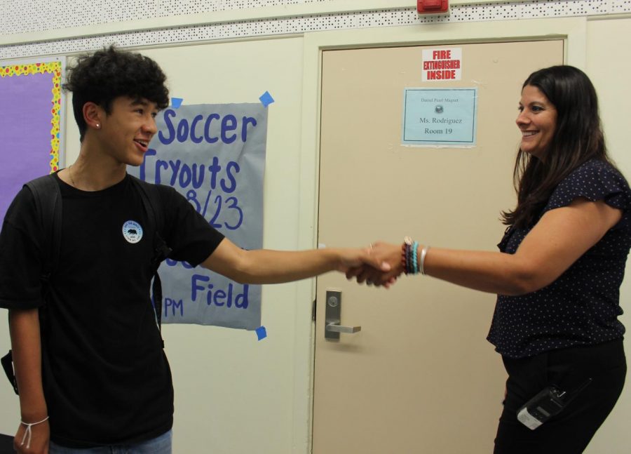 Sophomore Cameron Frank greets Principal Pia Damonte with a handshake and a smile on the first day of school on Aug. 20.