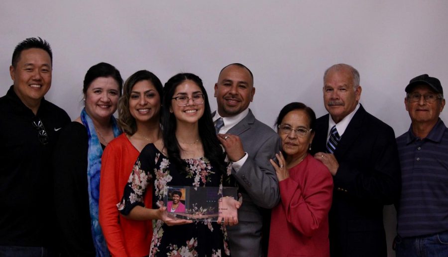 Staff writer Valeria Luquin takes a picture with her family to celebrate her winning the Gwen Ifill Student of the Year Award on Sept. 17. 
