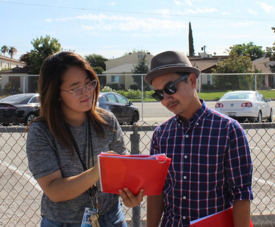 Math teachers Lori Seo and Tuan Duke Huynh look at procedures during the fire drill that took place toward the end of second period on Sept. 5.