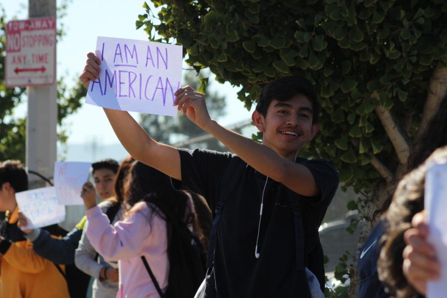 Junior Jesus Cortez shows off his sign to passing cars during the Deferred Action for Childhood Arrivals (DACA) protest/walkout on Nov. 12. 