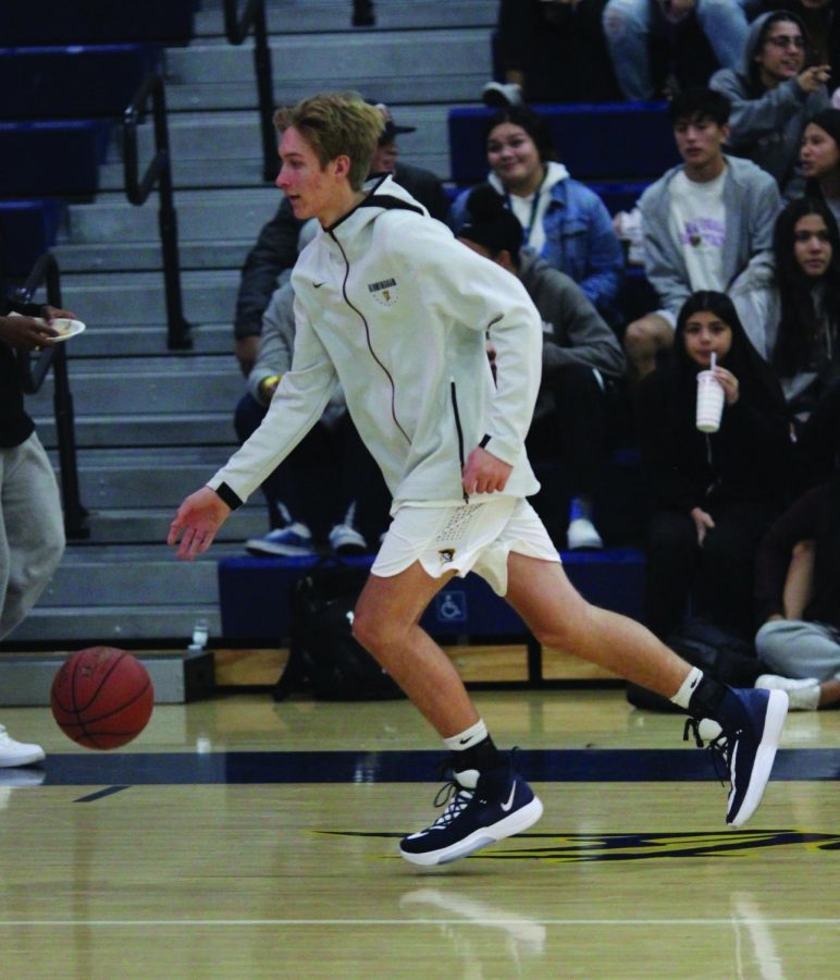 Senior varsity forward Cuyler Huffman warms up for a game against Palisades Charter High School on Nov. 21.