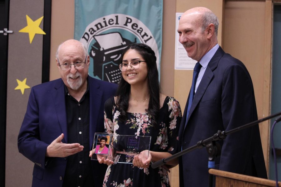 News Literacy Project board member Walt Mossberg, staff writer Valeria Luquin and Alan Miller founder and CEO of News Literacy Project smile to take a picture with the Gwen Ifill Student of the Year Award that Luquin received on Sept. 17.