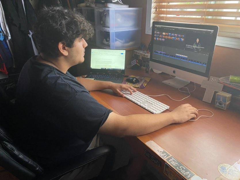 New Media Editor Christopher Sarenana edits a video for the website. The rest of the publication staff continues to produce content as well. 