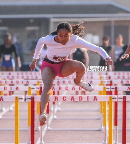 Senior Cassia Ramelb jumps over a hurdle during a track meet. Ramelb has been running track for BCCHS during all four years of high school.