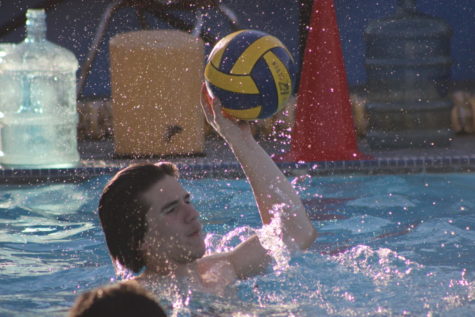 Senior August Defore gets ready to pass the ball during water polo practice on March 17.