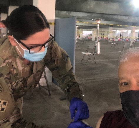 English teacher Ron Baer (right) receives his first dose of the Pfizer vaccine. Los Angeles Unified District is planning to reopen their schools for in-person instruction, which includes the possibilities of a hybrid schedule.  