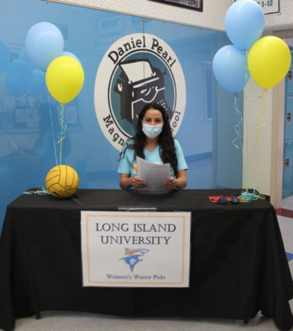 Senior Amelia Sanchez smiles as she officially commits to Long Island University to play water polo. Sanchez is the first DPMHS athlete in five years to play on a Division 1 sports team.