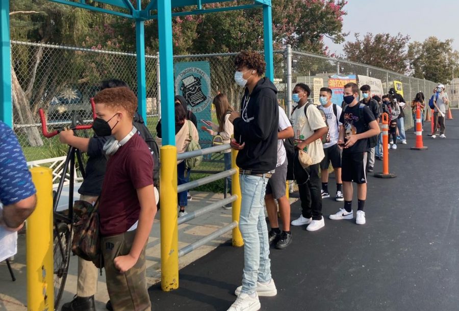 Students wait in line for up to at least 30 minutes to enter campus on the first day of classes on Aug. 16. An overload on the Daily Pass app during the first few days of the new school year made it difficult for students to show that they were cleared to go on campus.