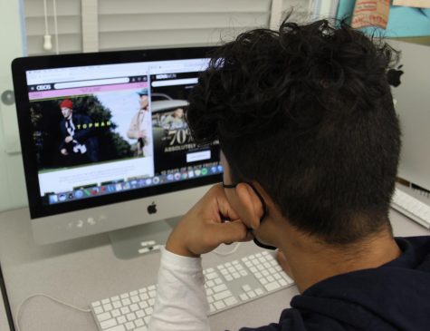 Senior Cameron Frank skims through online fast fashion stores on his computer.