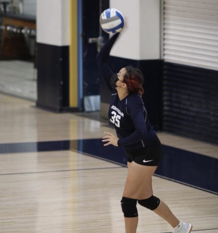Sophomore and Varsity Volleyball player, Cheyanne Lossino serves the ball against Cleveland Charter High School.