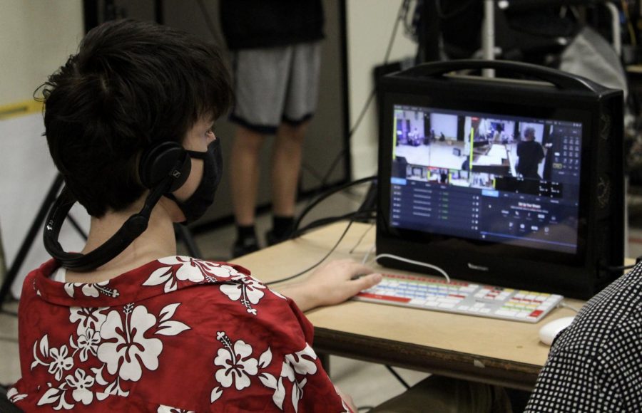 Junior Dashiell Dekker monitors several camera angles and mics as students set up to record. Dekker has experience editing videos, but this is his first time participating in World Music Day.