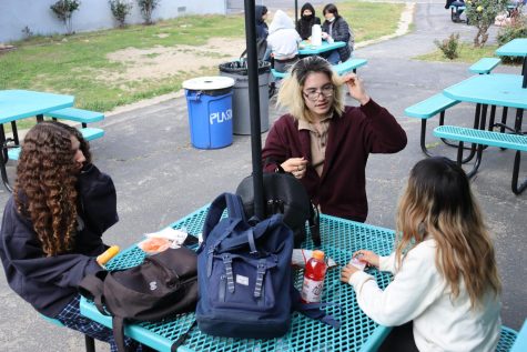 Juniors Giselle Khalil, Vince Gillen and Nancy Medrano hang out outside during lunch without masks on Feb. 23. 