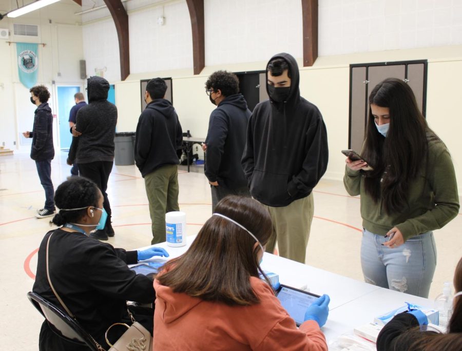 Students line up for weekly COVID-19 testing in the MPR. Even though those with medical exemptions from the vaccine take safety precautions, they still face judgement. 