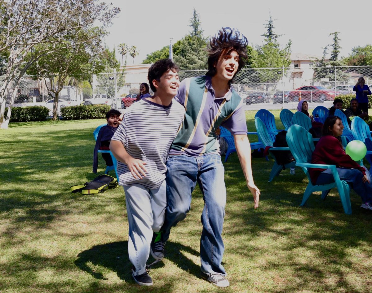 Seniors Mose Judge-Glascock and Sebastian Olfatmanesh participate in a three-legged race during the pep rally on April 23.