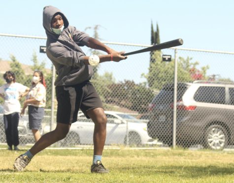 Freshman Monty Coleman strikes out while playing wiffle ball in the grove on May 12 during fourth period.
