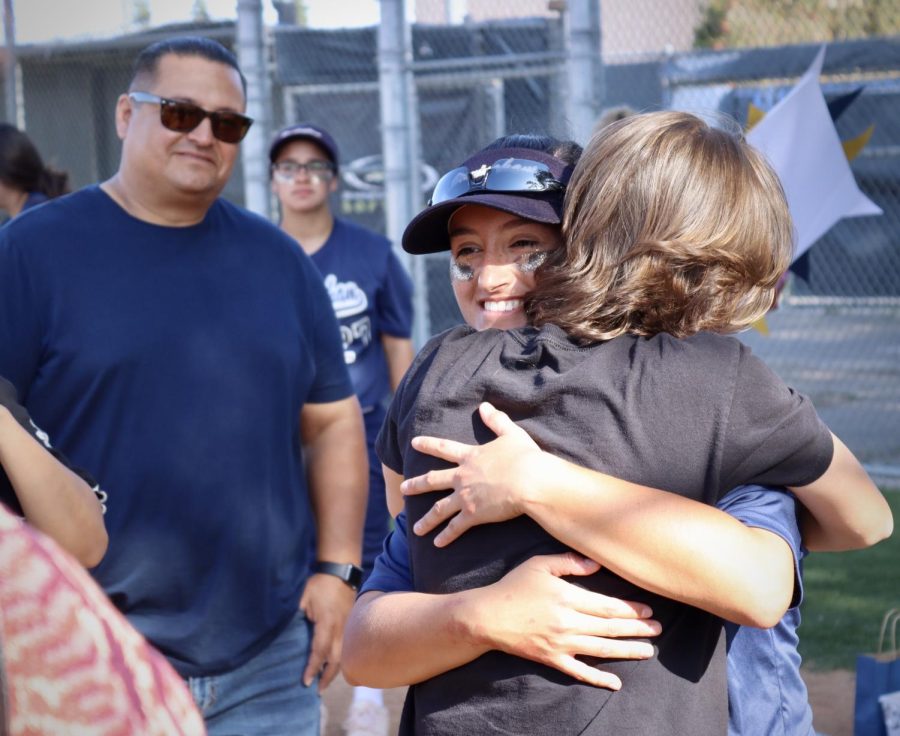 Varsity softball center fielder Nadia Montiel embraces a close family friend during the team’s emotional Senior Night ceremony on May 5. The ceremony follows Montiel
and the Birmingham Community Charter High School Patriot’s second to last season game where they secure a 5-1 victory over the Cleveland High School Cavaliers.