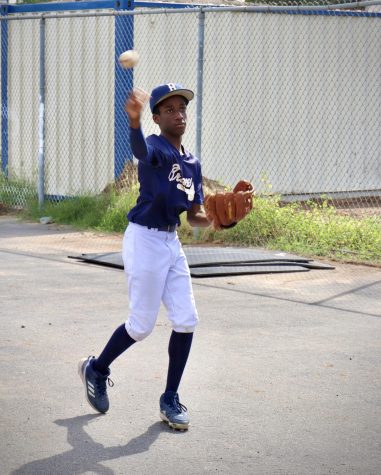 JV baseball second baseman, Zion Waddell, practices his throw at Birmingham Community Charter High School. 