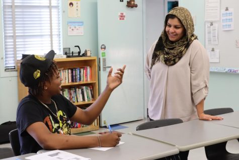 Junior Shawn Abram-Marsden catches up on class criteria with resource teacher Sadia Aziz on Back to School Night. Marsden was told to practice his writing skills, so he wrote a letter on things he loved about a family member. 