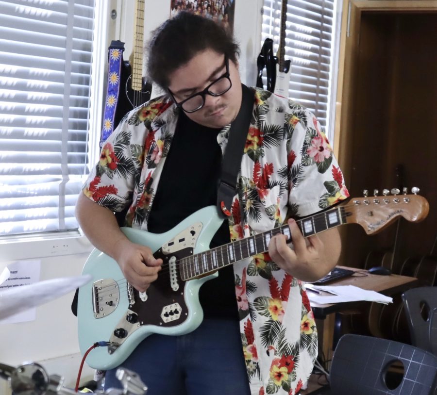 Sophomore Damien Cacho practices his guitar performance for World Music Day in music teacher Wes Hambrights classroom during lunch on Oct. 4.