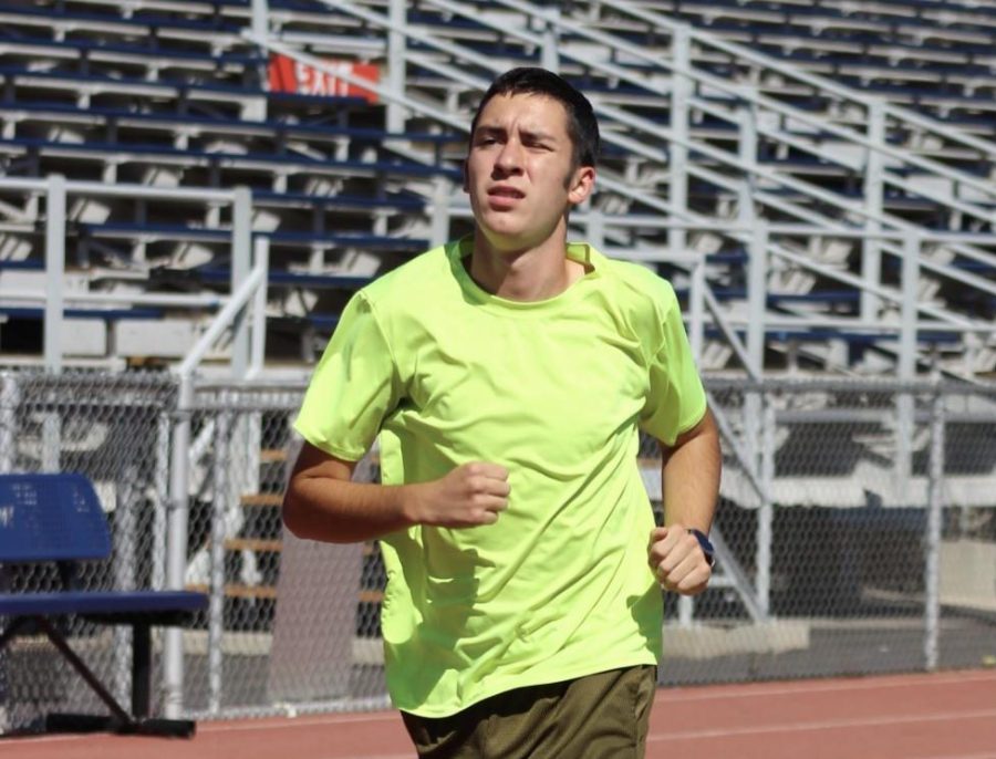 Sophomore Deven Szymczak jogs on the track during cross country practice on Sept. 22.
