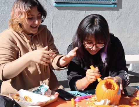 Freshmen Eden Ivgy and Jenny Marquez carve pumpkins as part of an Art Club activity during lunch on Oct. 28. 