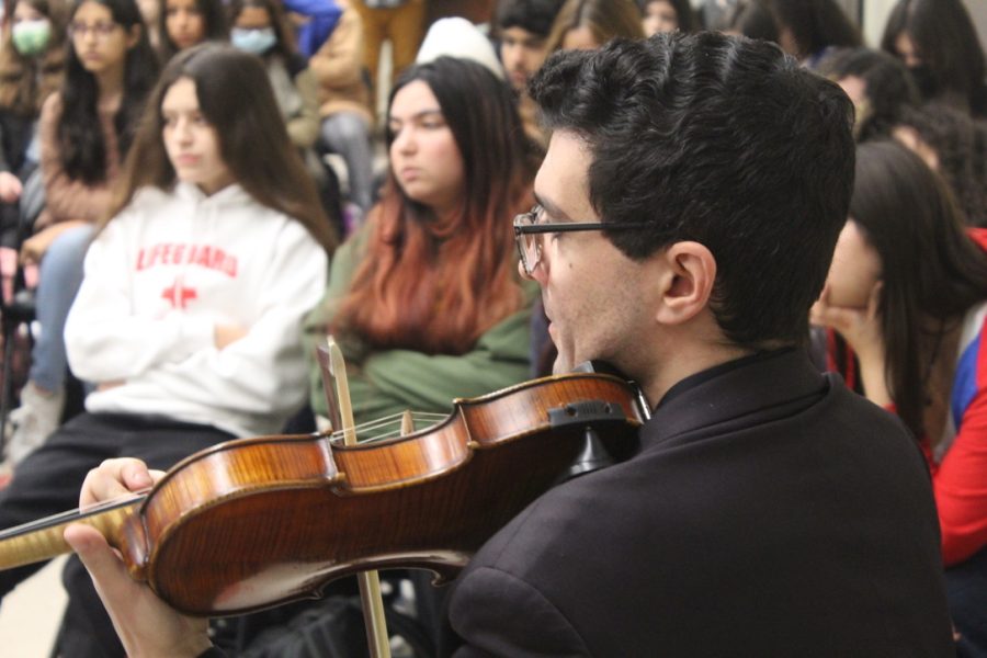 A Kadima Conservatory of Music member performs for students on Dec. 7.