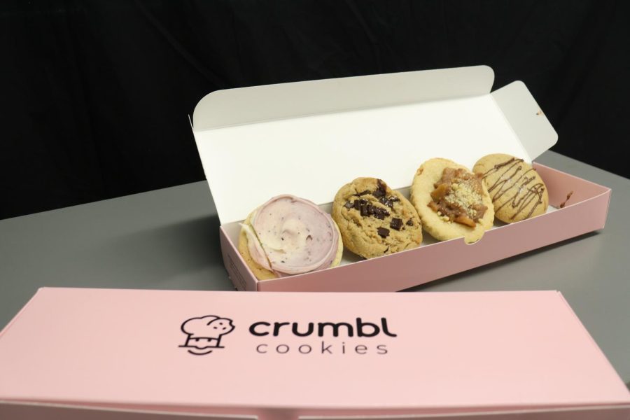 A+sample+of+Crumbl+Cookies+sit+in+an+open+box.+These+cookies+tasted+as+good+as+they+looked+but+cost+a+lot+of+dough%2C+amounting+to+%2420+for+four+humongous+treats.