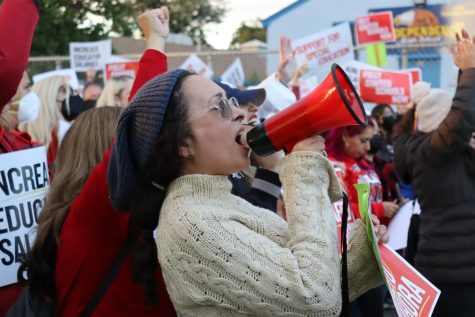Sylvia Garcia, a Bassett Street Elementary School teacher, shouts into a megaphone during a United Teacher Los Angeles rally on Dec. 5. The rally involved hundreds of Los Angeles Unified School District (LAUSD) employees, who gathered next to LAUSD Local District Northwest headquarters to call for higher salaries and smaller class sizes. 