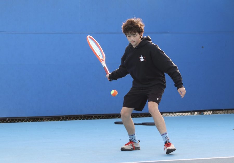 Tennis player Mose Judge prepares to hit a tennis ball with his racket during after school practice at Birmingham Community Charter High School on Jan. 18. 