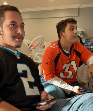 Brothers Jason and Daniel Arevalo watch football together. 
