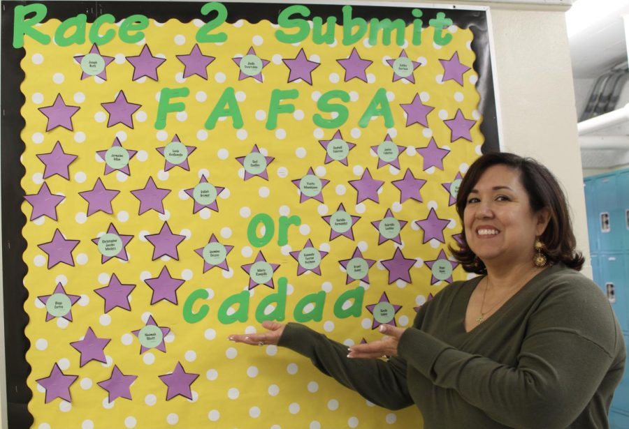 Academic+Counselor+Martina+Torres+stands+in+front+of+the+FAFSA+and+CADAA+board+on+Jan.+26.+Torres+adds+the+name+of+senior+students+who+have+completed+their+FAFSA+or+CADAA+to+mark+the+overall+student+progression.+